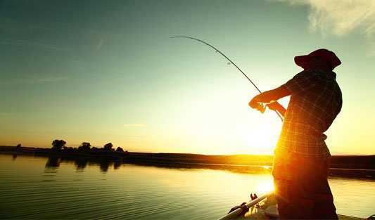 Norfolk Broads Fishing - Fisherman fishing on a boat